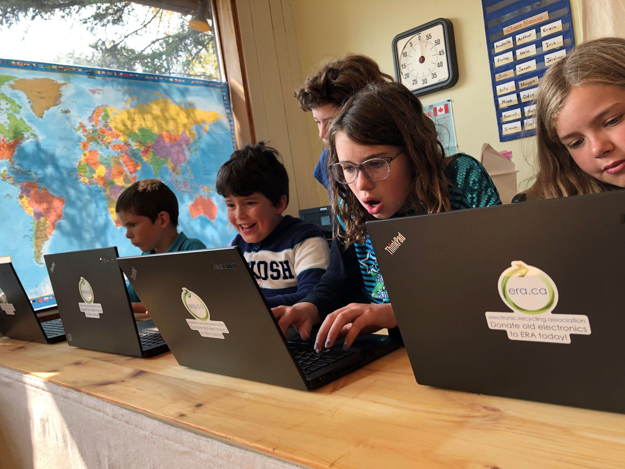 A classroom of students working on refurbished ERA laptops