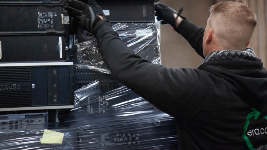 Hands taping a box of equipment for shipping
