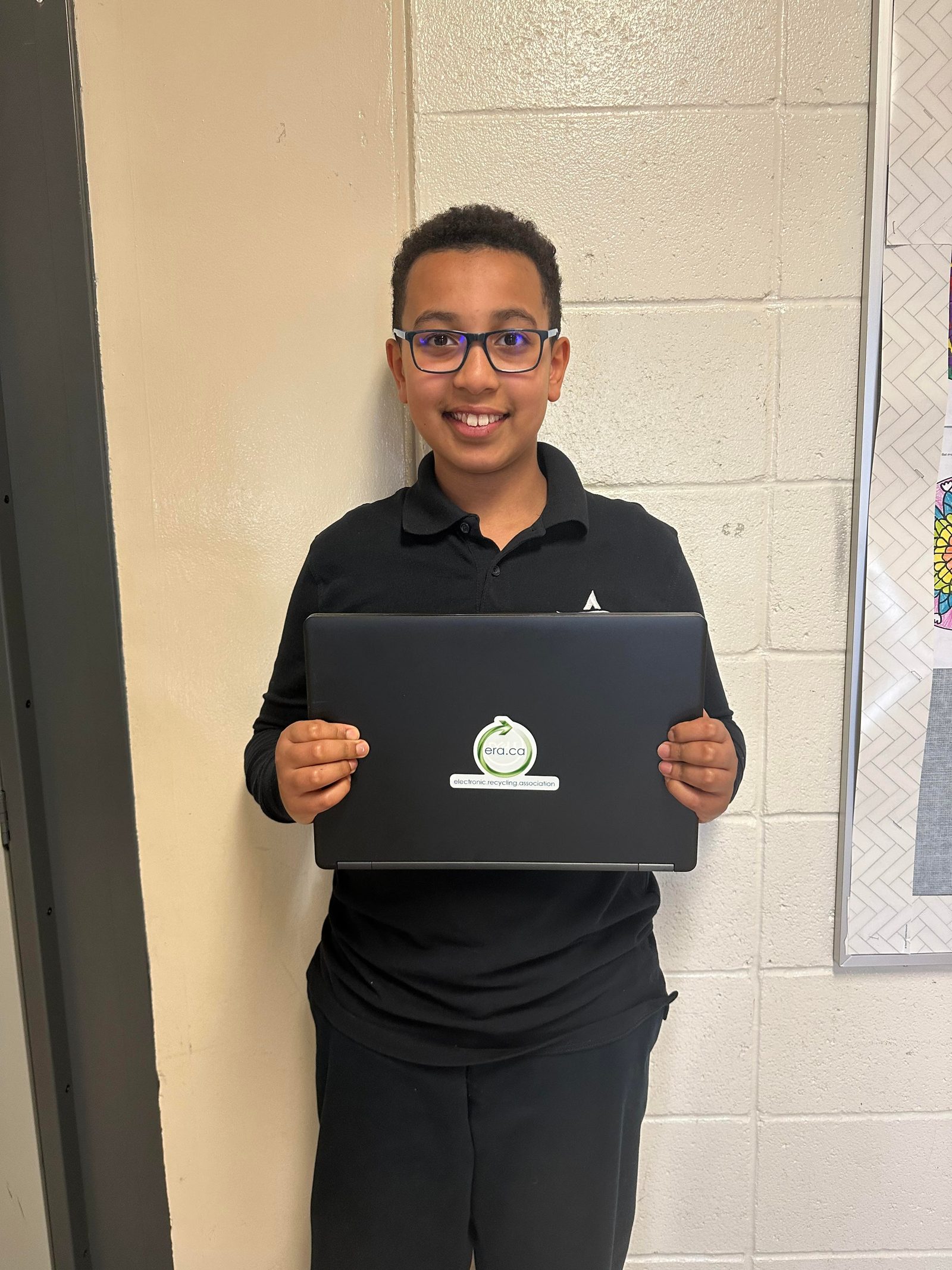 A student working on a refurbished ERA laptop
