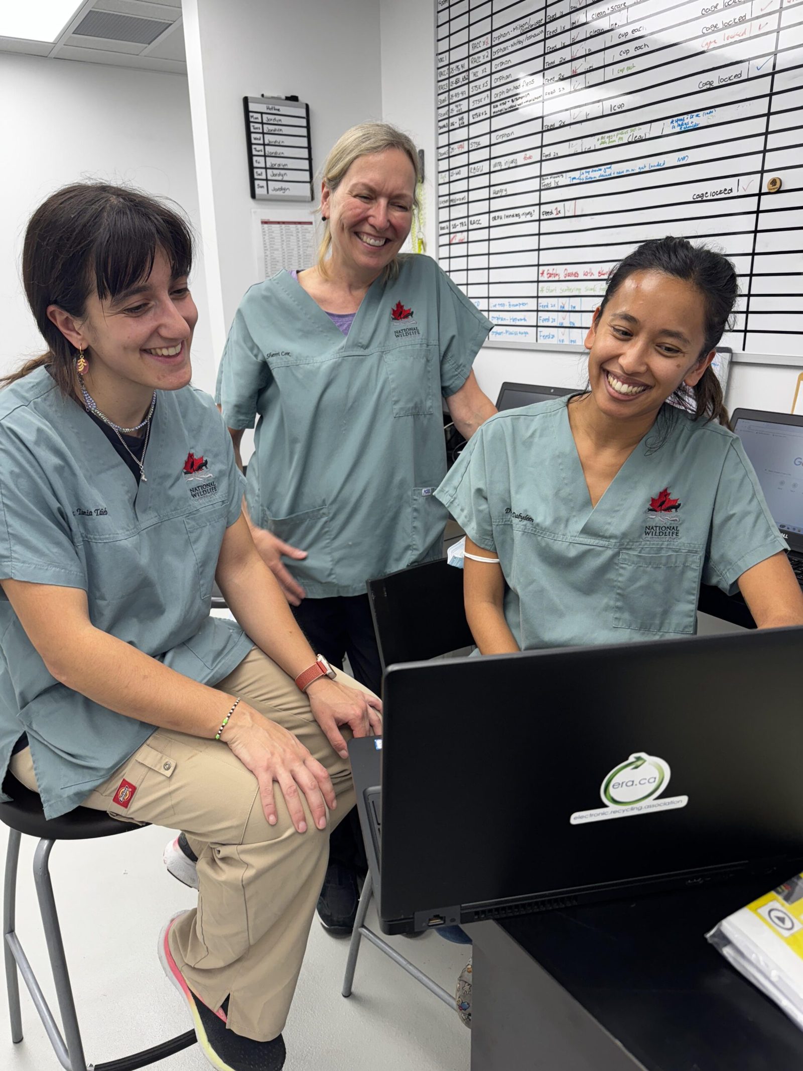 Charity-partner staff using a donated ERA laptop together