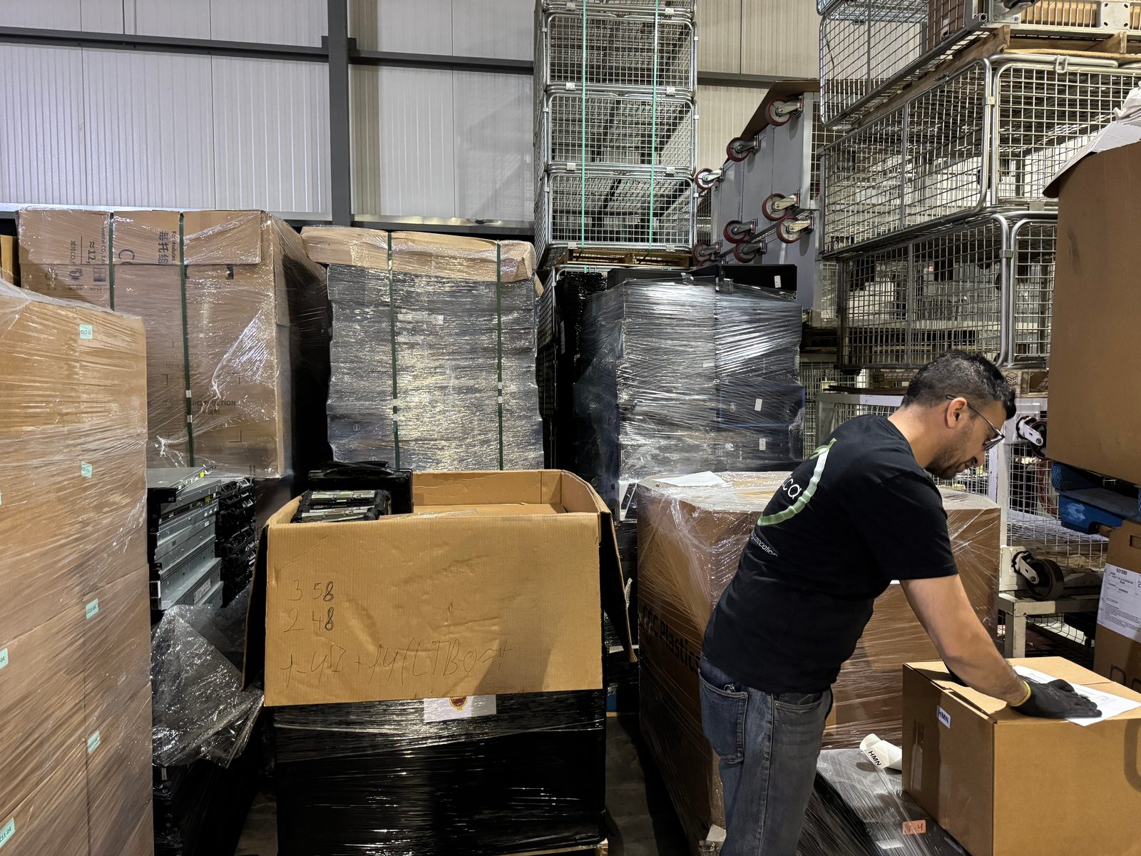 ERA technician inventorying palleted equipment in the secure intake area