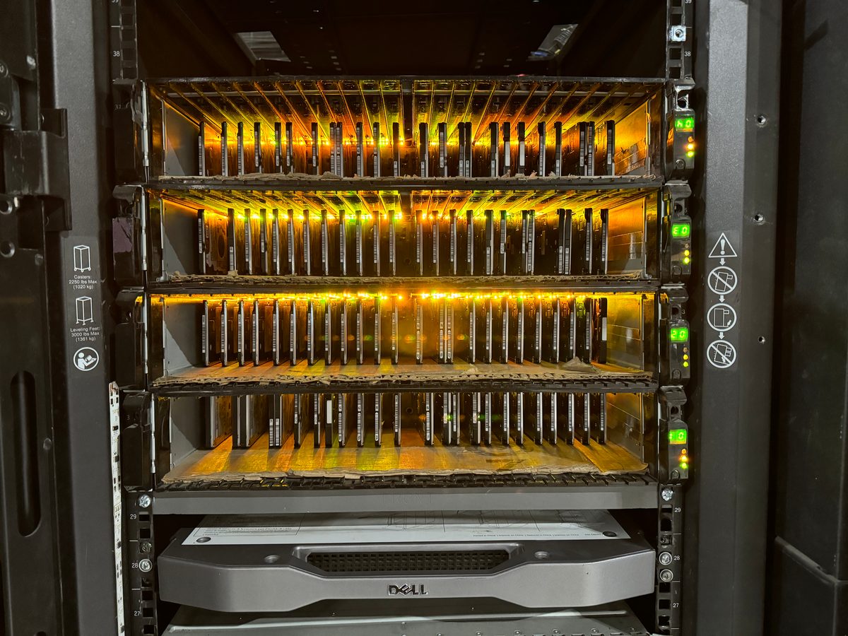 Server with hard drives glowing in racks — staged for secure IT asset disposition